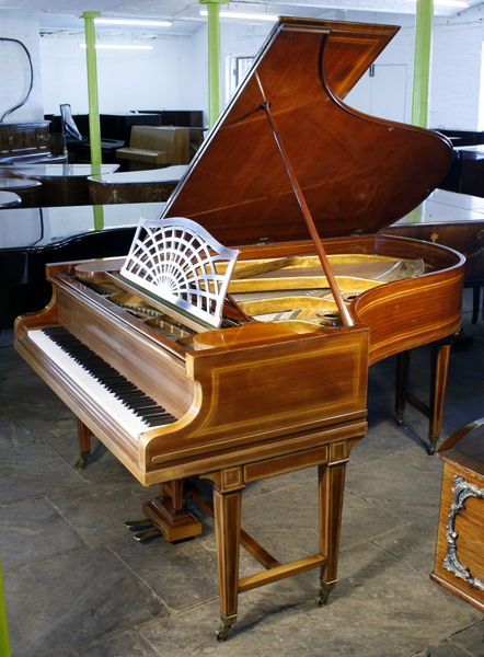 Reconditioned,  1884, Bechstein Model B grand piano with a mahogany case and gate legs, inlaid with satinwood stringing. Piano has an eighty-eight note keyboard and a two-pedal lyre