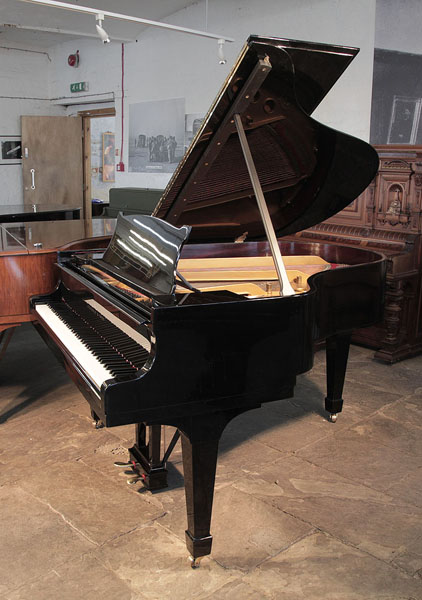 Restored, 1936, Steinway Model M grand piano for sale with a black case and spade legs. Piano has an eighty-eight note keyboard and a two-pedal lyre. 