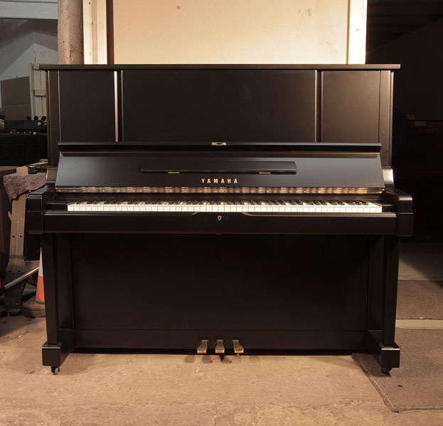 Reconditioned, 1981, Yamaha YUX upright piano for sale with a satin, black case and brass fittings. Piano has an eighty-eight note keyboard and three pedals. 
 