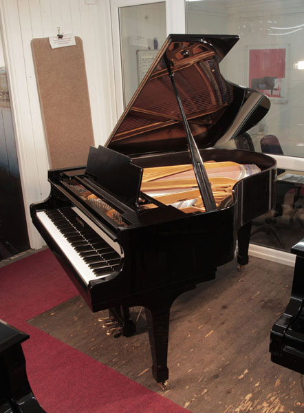 Reconditioned, 1976, Kawai KG-2C grand piano for sale with a black case and spade legs