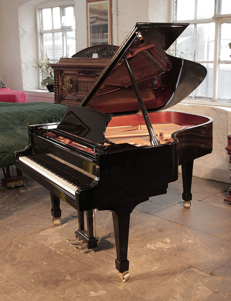 Toyama TC-187 grand piano for sale with a black case and spade legs