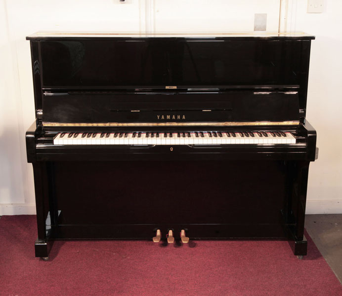 Reconditioned, 1974, Yamaha U1 upright piano for sale with a black case and brass fittings. Piano has an eighty-eight note keyboard and three pedals.  