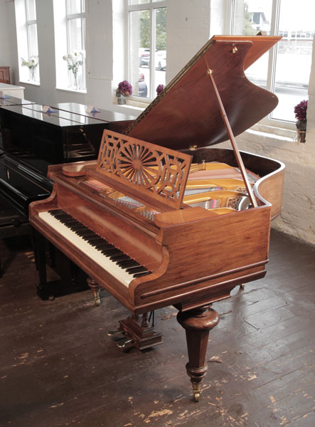 Rebuilt, 1914, Chappell baby grand piano with a polished, mahogany case and turned legs. Piano has an eighty-five note keyboard and a two-pedal lyre. 