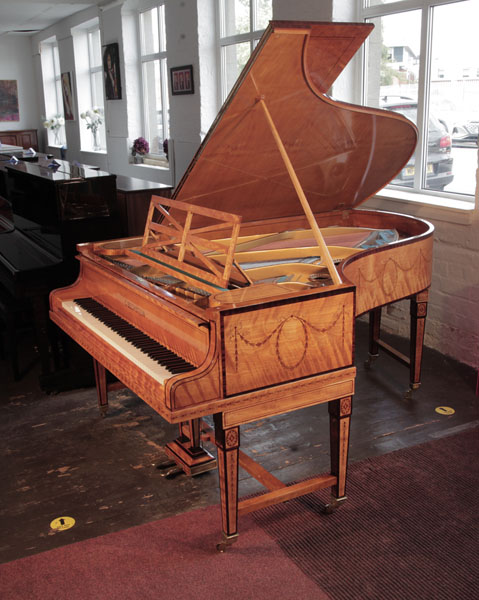 Restored, 1910, Bechstein Model B grand piano with a book-matched, satinwood case with boxwood stringing. Piano has gate legs attached with a cross stretcher. Entire cabinet inlaid with swagged bellflowers and bows. Piano has an eighty-eight note keyboard and a two-pedal lyre