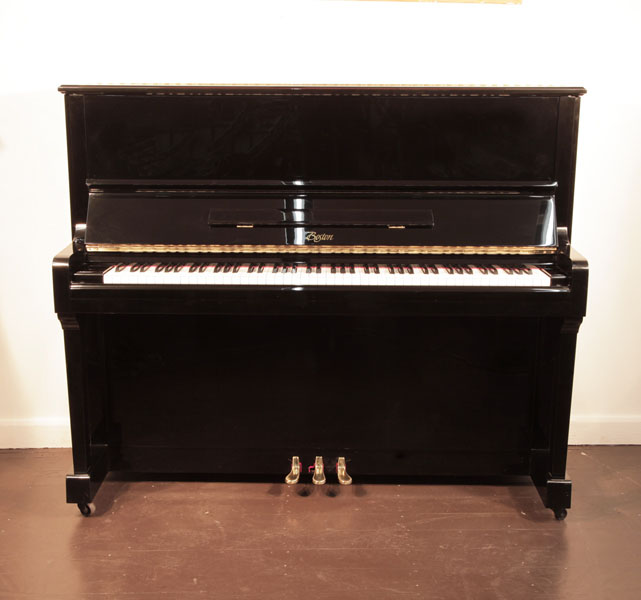 Reconditioned, 1999, Boston UP-125E  upright piano with a black case and brass fittings. Piano has an eighty-eight note keyboard and three pedals