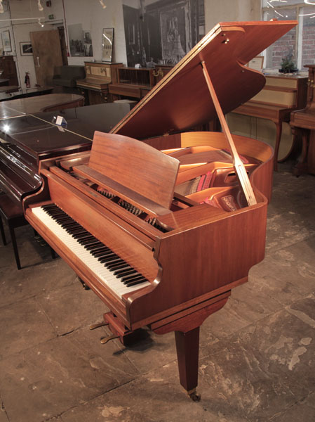  Reconditioned, 1975,  Broadwood baby  grand piano for sale with a mahogany case and square, tapered legs. Piano has an eighty-eight note keyboard and a two-pedal lyre. 