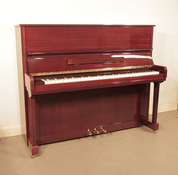 Reconditioned,  2000, Pianova upright piano with a mahogany case and brass fittings. Piano has an eighty-eight note keyboard and three pedals. 