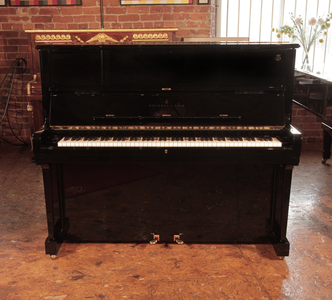 Reconditioned, 2002, Steinway Model V upright piano with a polished, black case with brass fittings. Piano frame signed by Lang Lang. Piano has an eighty-eight note keyboard and two pedals