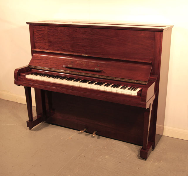 A 1936, Steinway Model V upright piano with a quartered, mahogany case and brass fittings. Piano has an eighty-eight note keyboard and two pedals. 