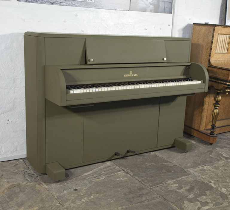 A 1944, Steinway 'Victory Vertical' G.I. upright piano for sale with an olive drab case. This upright was airdropped onto battlefields during WWII for the American troops. Piano has an eighty-eight note keyboard and three pedals. 