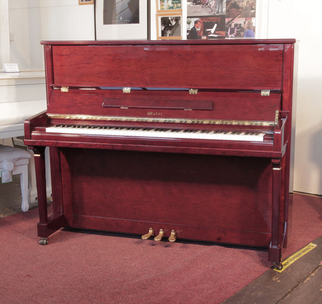 Reconditioned,  2010, Weber TU-122S  upright piano for sale with a mahogany gloss case and brass fittings. Piano has an eighty-eight note keyboard and and three pedals. 