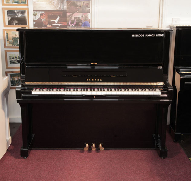 Reconditioned, 1974, Yamaha U3 upright piano for sale with a black case and brass fittings. Piano has an eighty-eight note keyboard and three pedals.  